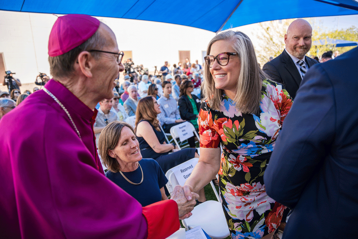 Arizona State Gov. Katie Hobbs shakes Bishop Emeritus Olmsted's hand