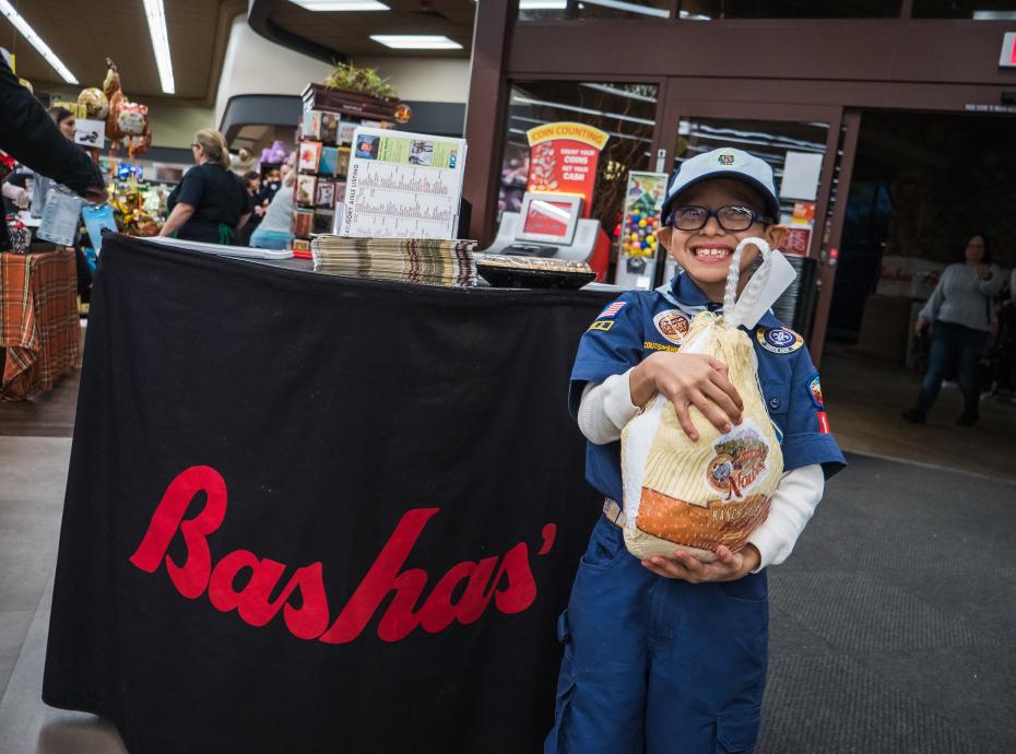 Young boy scout holding a turkey