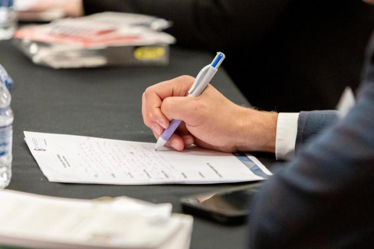 Close up of man's hand writing a letter