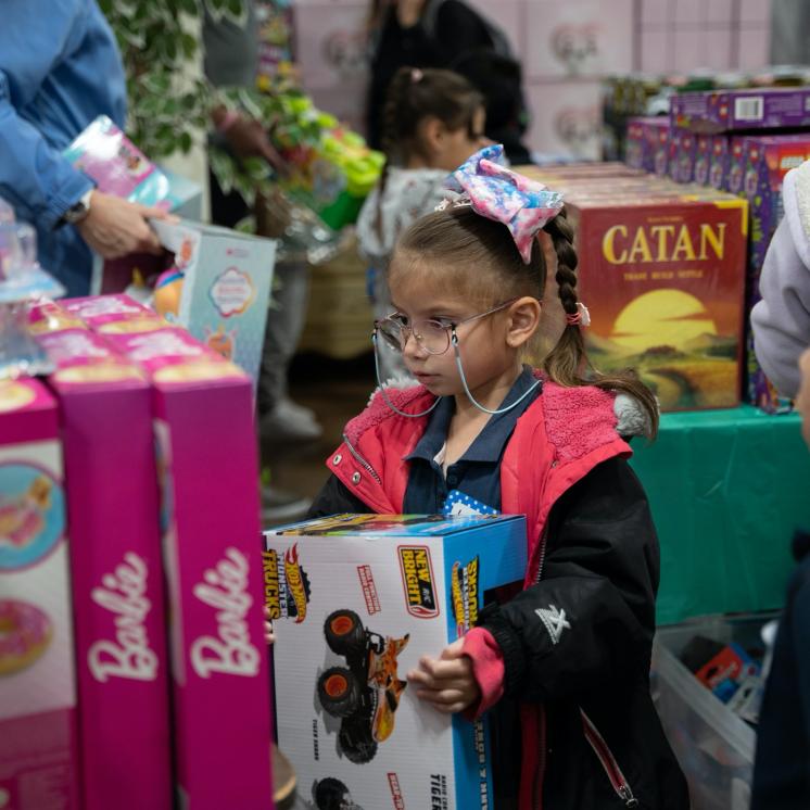 A girl at the Palomino Christmas event looks for toys for her family.