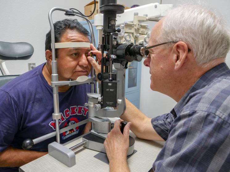 A guest has his eyes examined in SVdP's medical clinic.