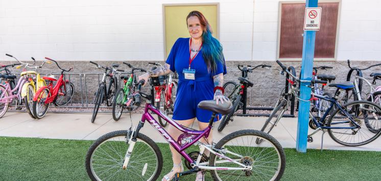 Alinda Nelson poses with her bike outside of Ozanam Manor.