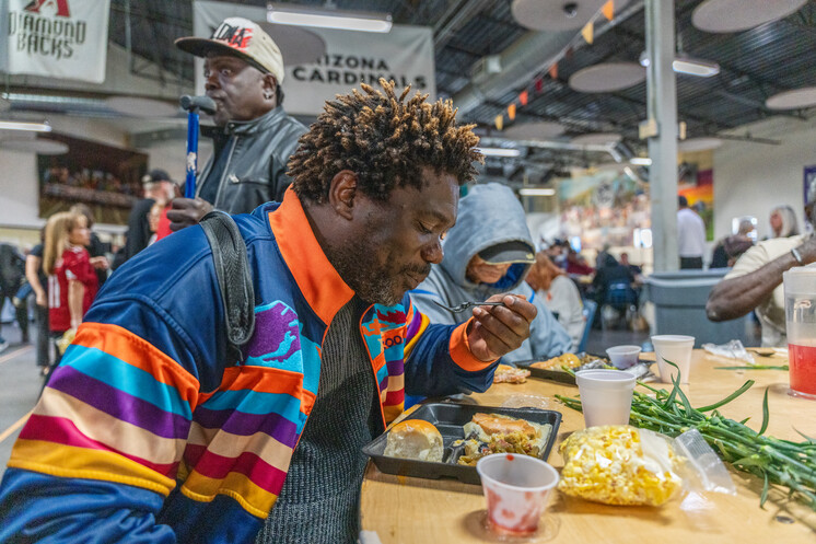 A man eating his Thanksgiving meal at the Phoenix Dining Room.
