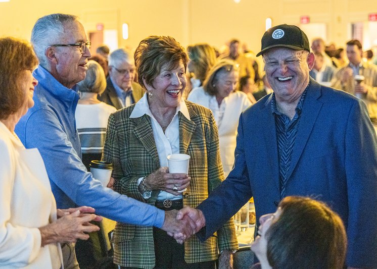 Doctor Snyder shaking hands with a donor at SVdP Annual Restoring Hope Breakfast event