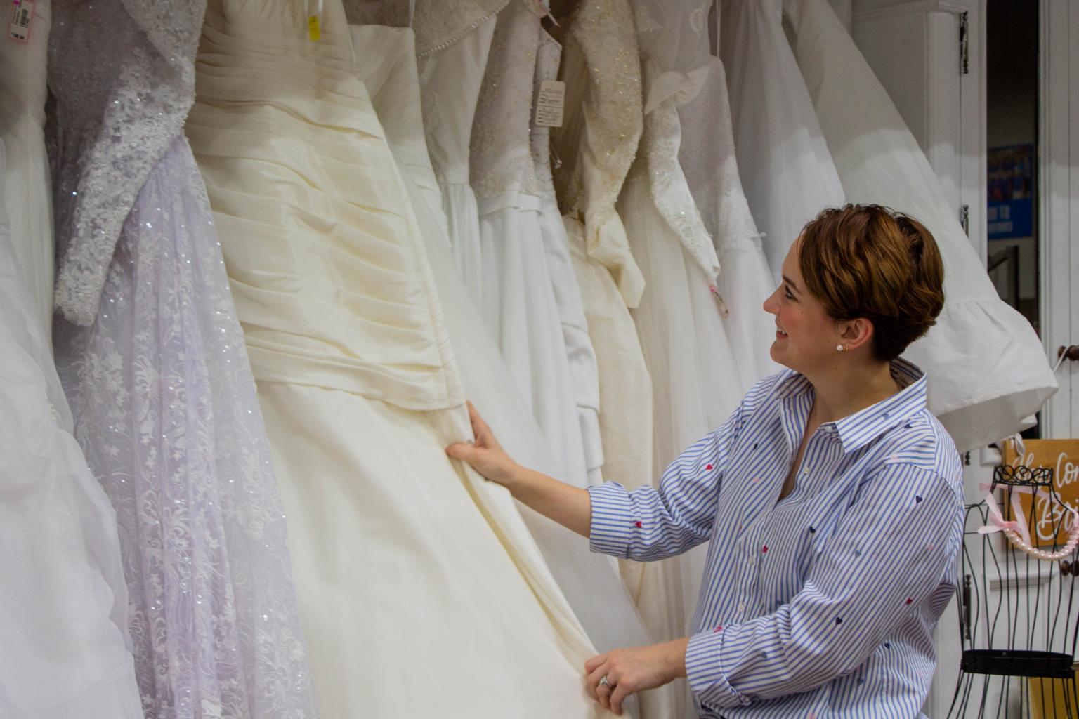 Mackenzie sorting through wedding dresses