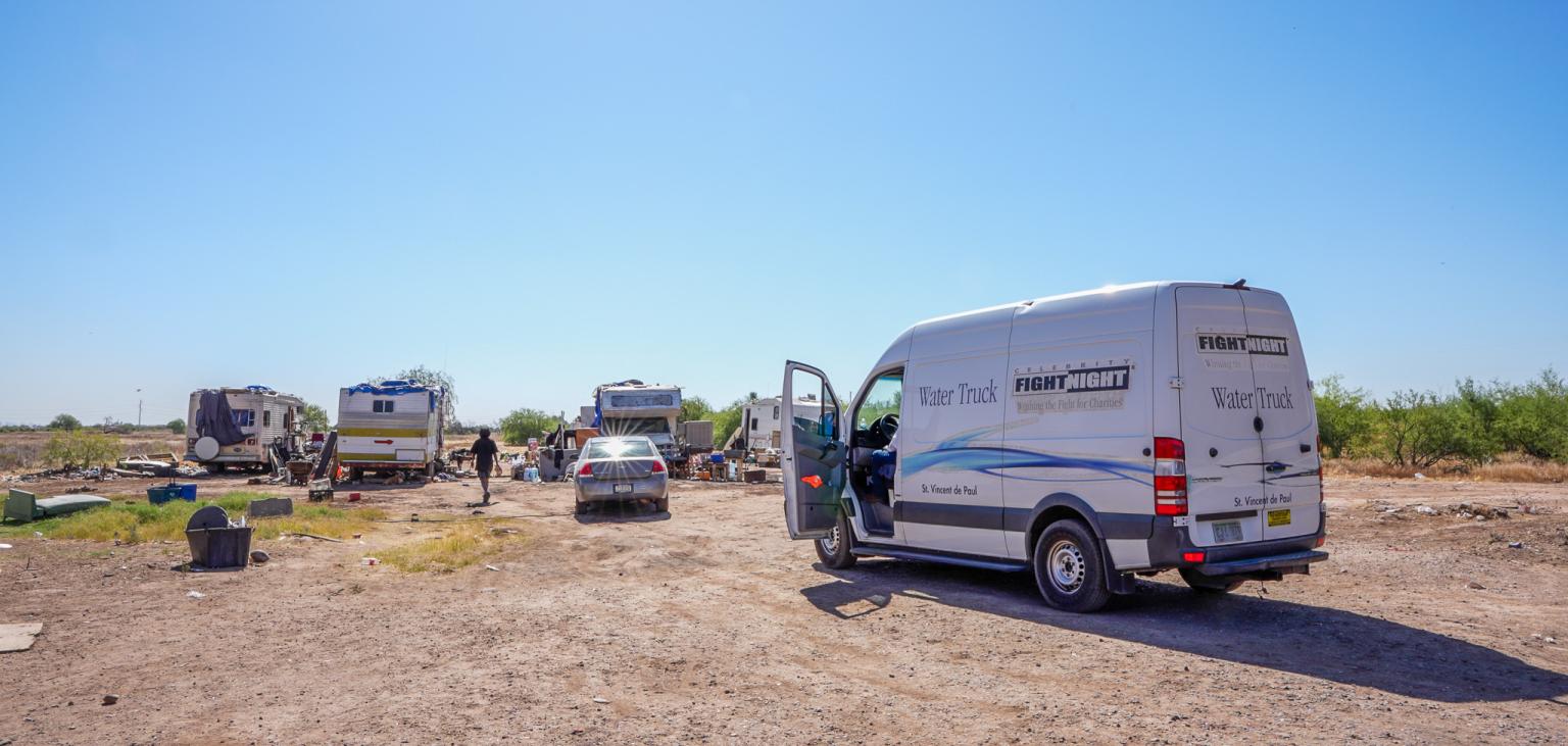 The SVdP Water Truck parks at a family's encampment on the Gila River Indian Reservation.