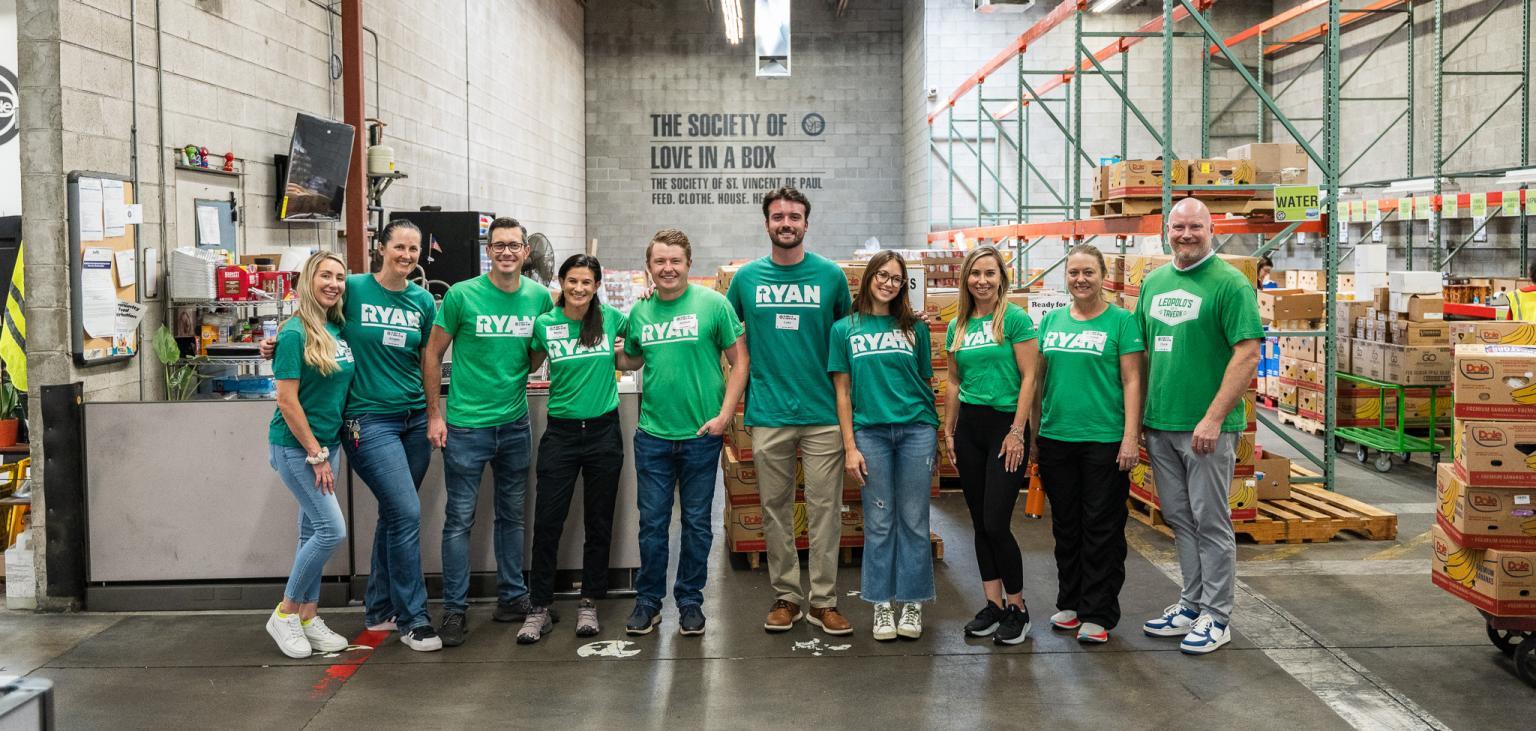 Ryan Companies staff poses in SVdP's Food Reclamation Center.