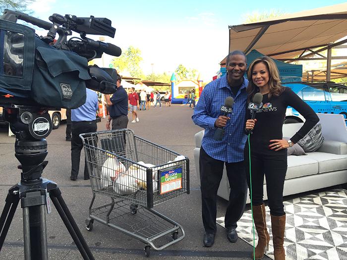 Bruce Cooper and Caribe Devine pose for a photo in front of Bashas' on Turkey Tuesday.