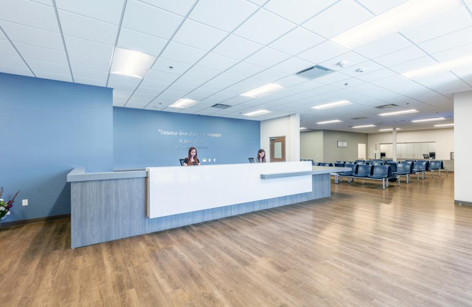 Resource Center Header Wide view of a waiting area with two women sitting behind a desk