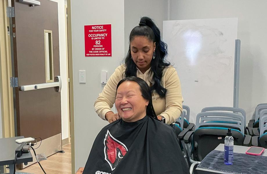 Ann Marie gets a hair cut from a volunteer from Greater Good Phoenix