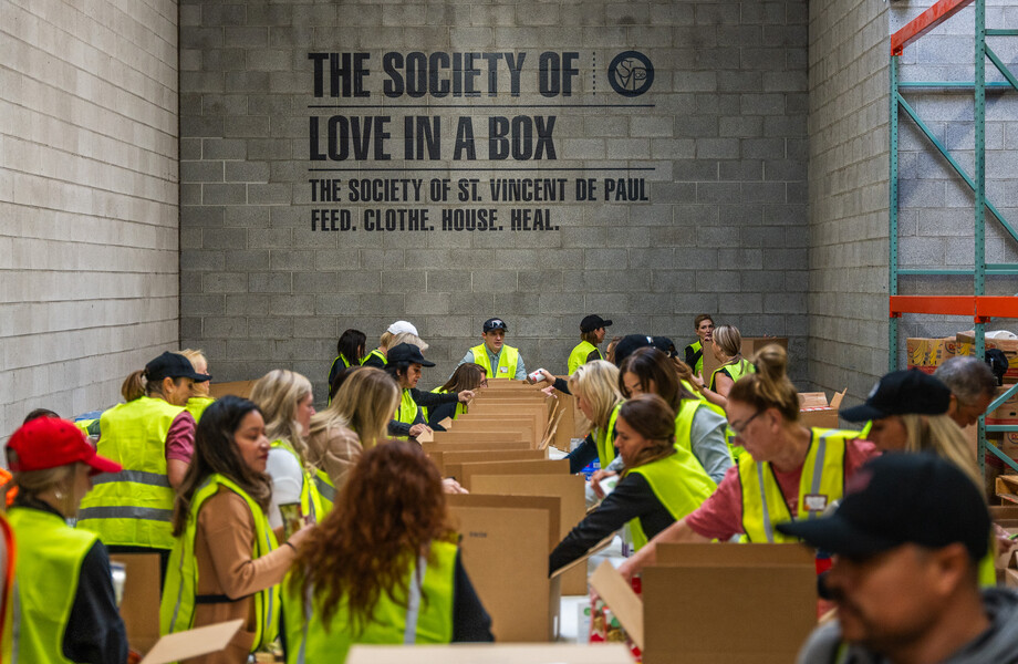 A group of volunteers put together food boxes.
