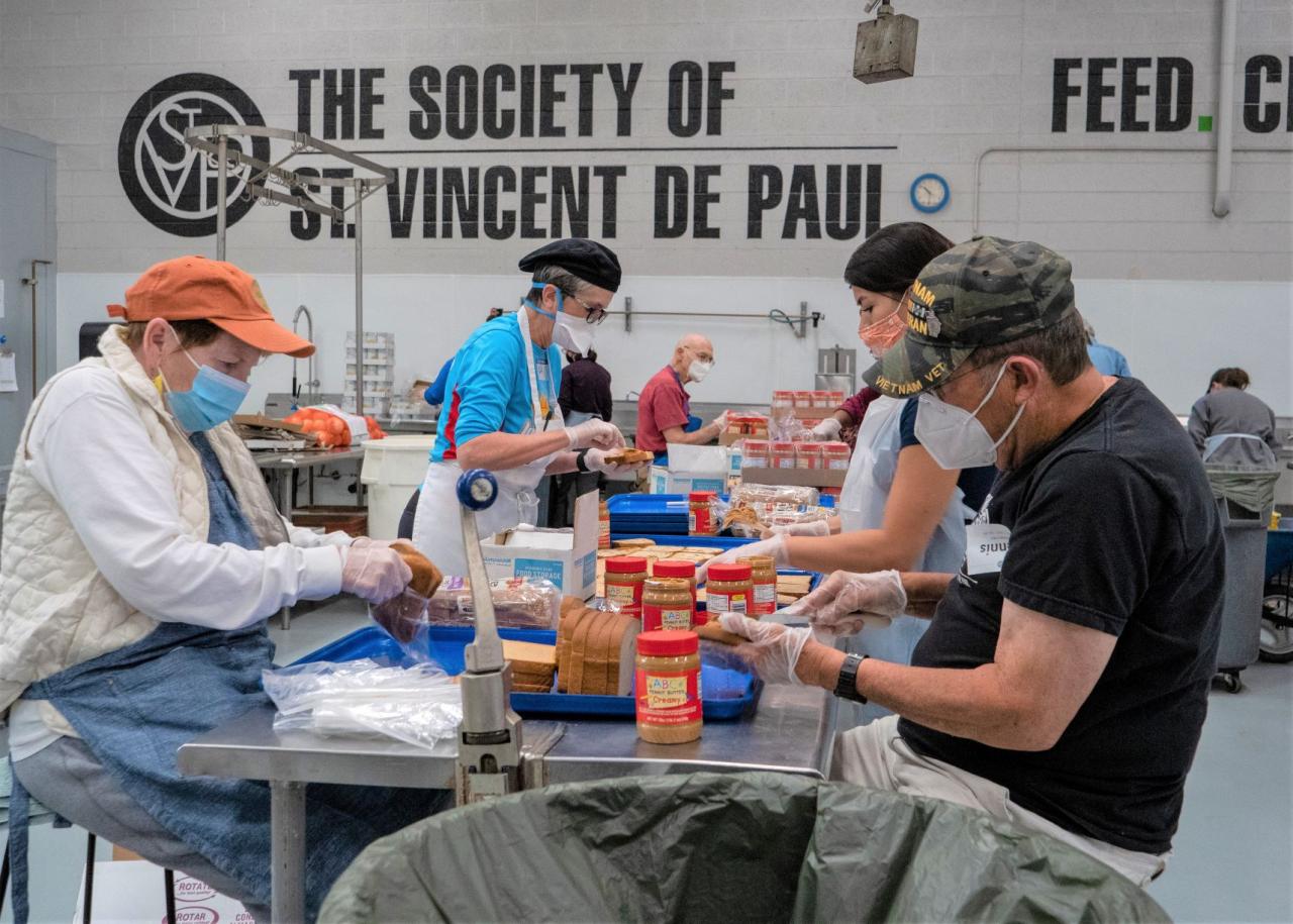 Volunteers making peanut butter and jelly sandwiches