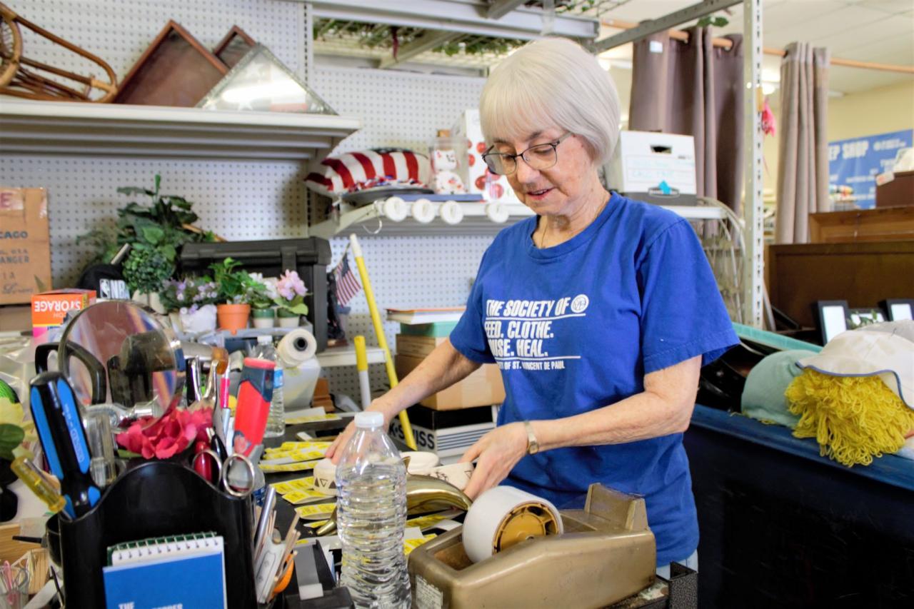 Older woman sorts goods in a store