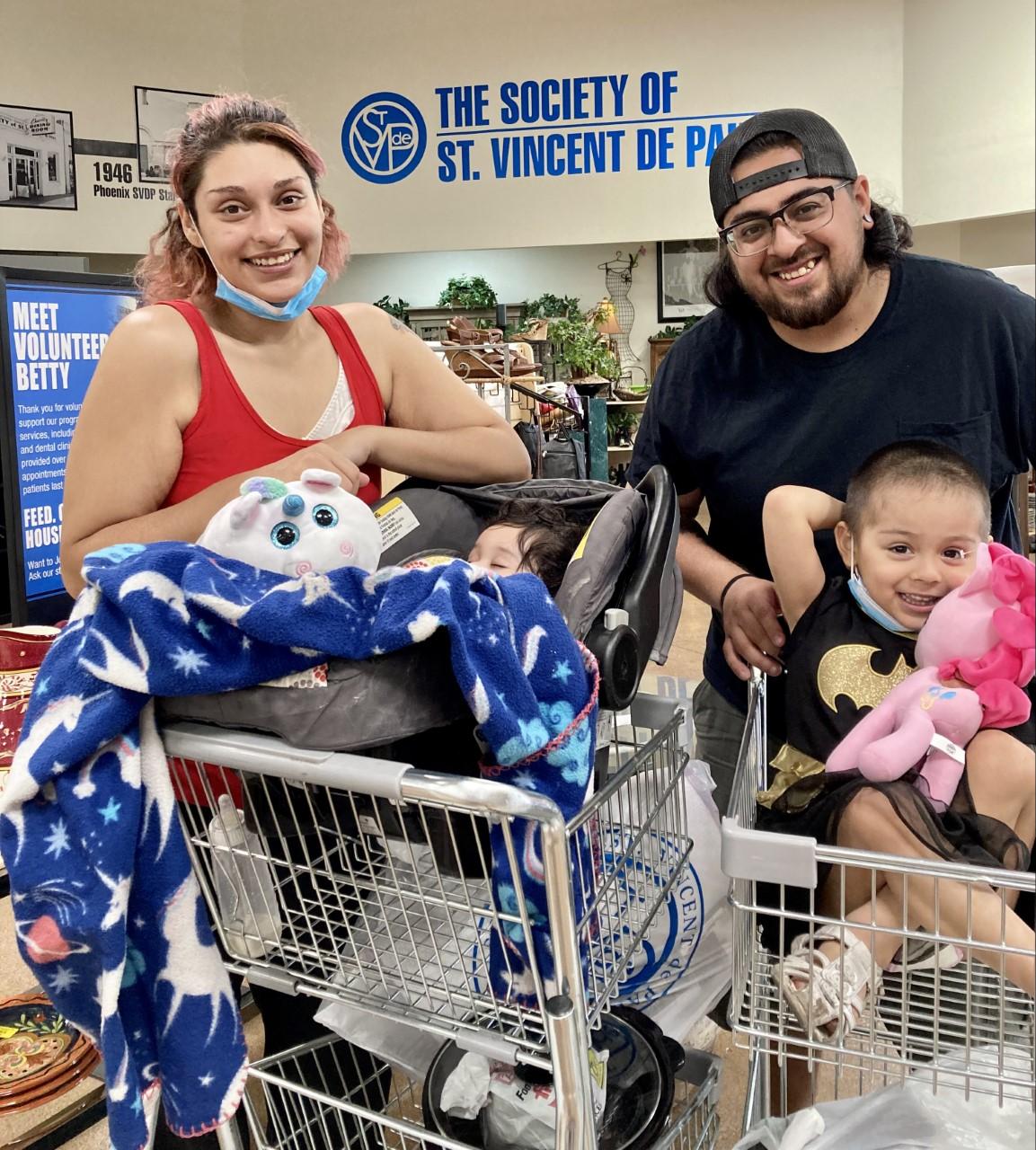 Man and woman smiling over a shopping cart