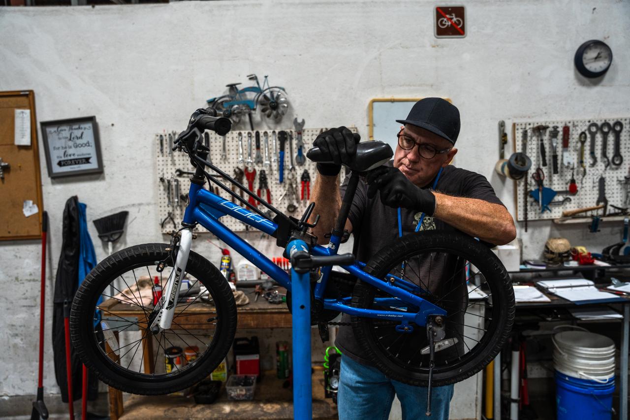 Ricky works on a bike in the bike shop.