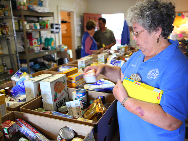 woman packing boxes with food
