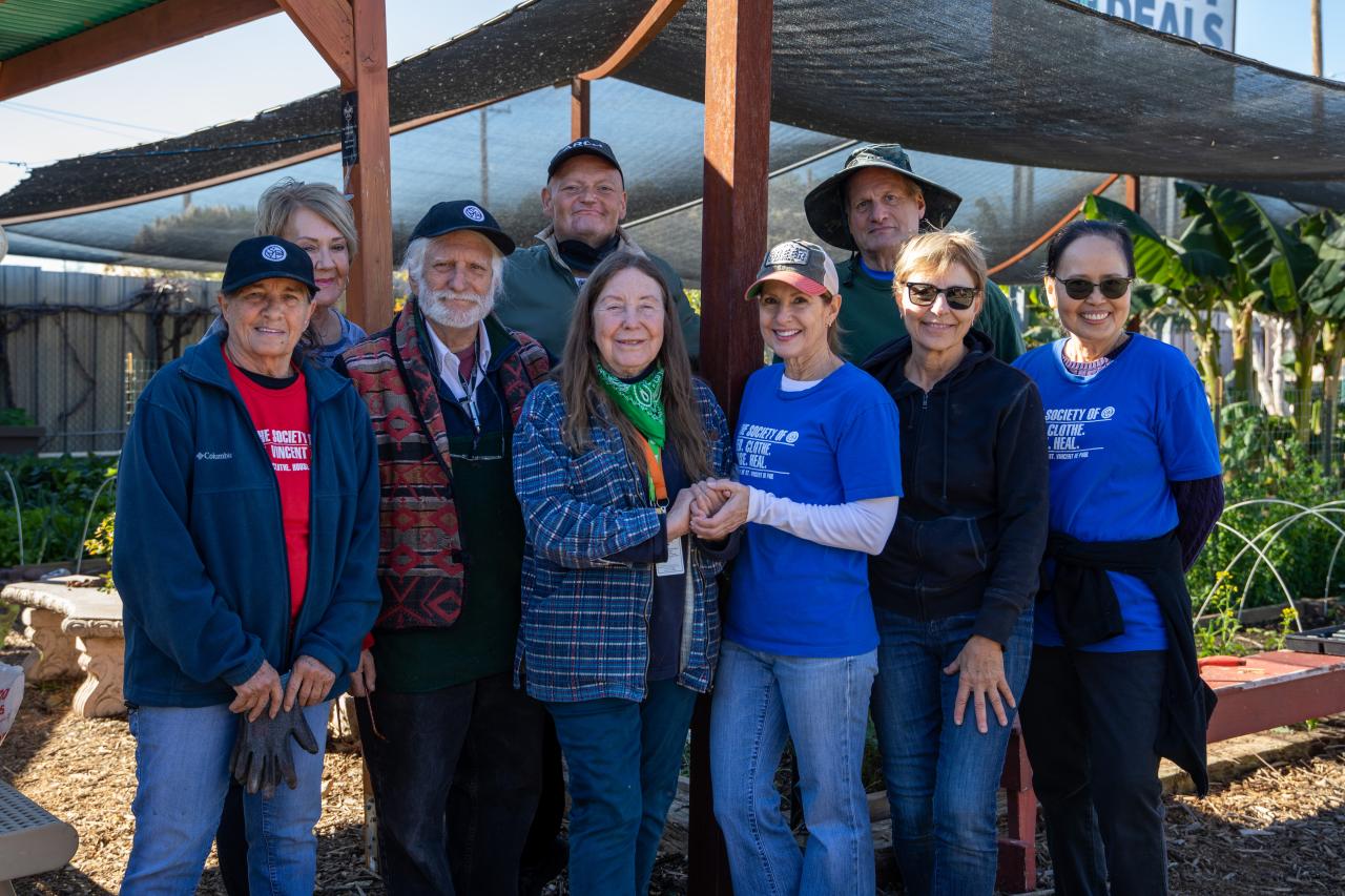 Mesa urban farm volunteers stand and pose together