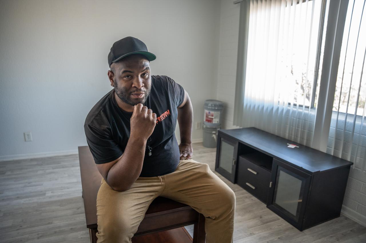 Diriki sits in the living room to his new apartment.