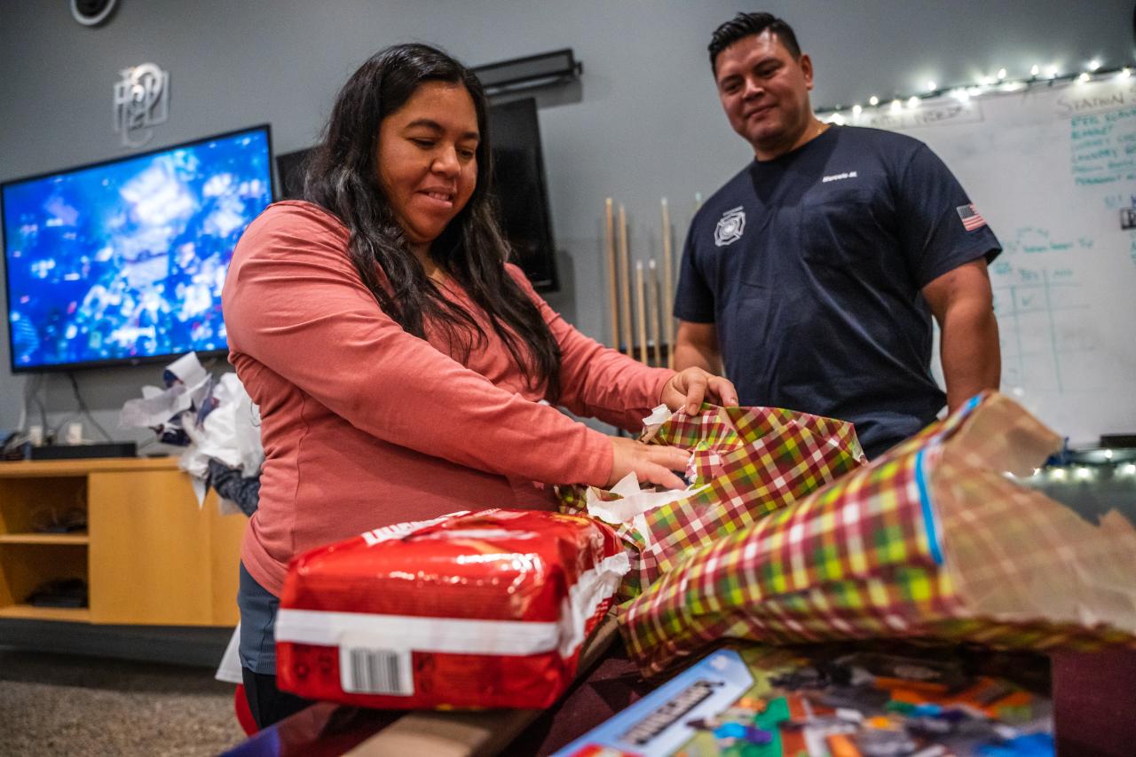 Nashelly opens presents from the Laveen Fire Station, including some diapers for her soon-to-be fourth child.