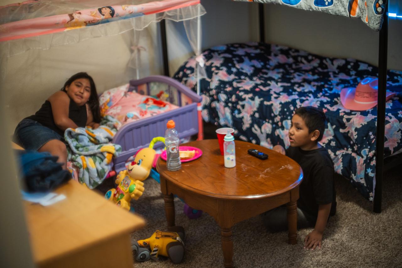 Julio's two oldest children hang out in their bedroom.