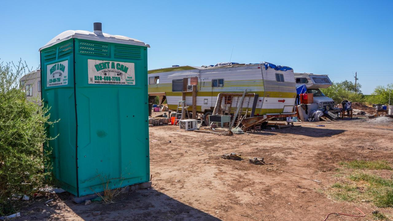 The encampment on the Gila River Indian Reservation has no plumbing, so the family has to use an outhouse.