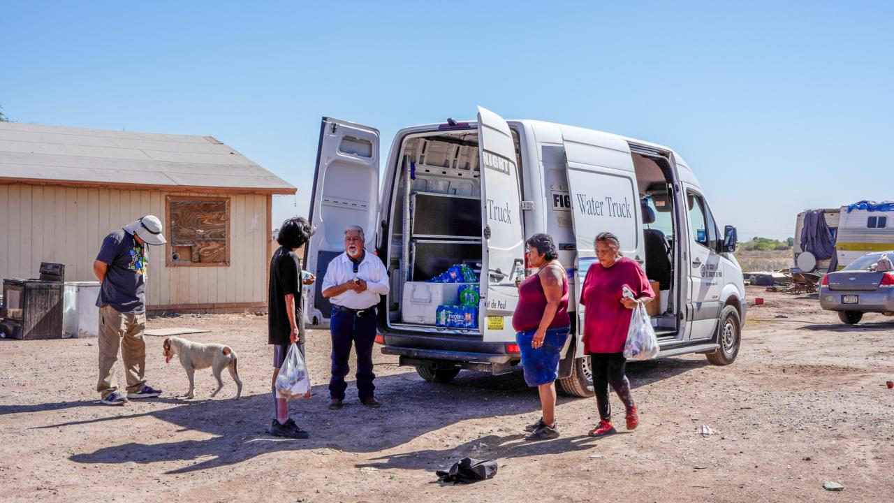 The family talks with Joseph at the Water Truck.