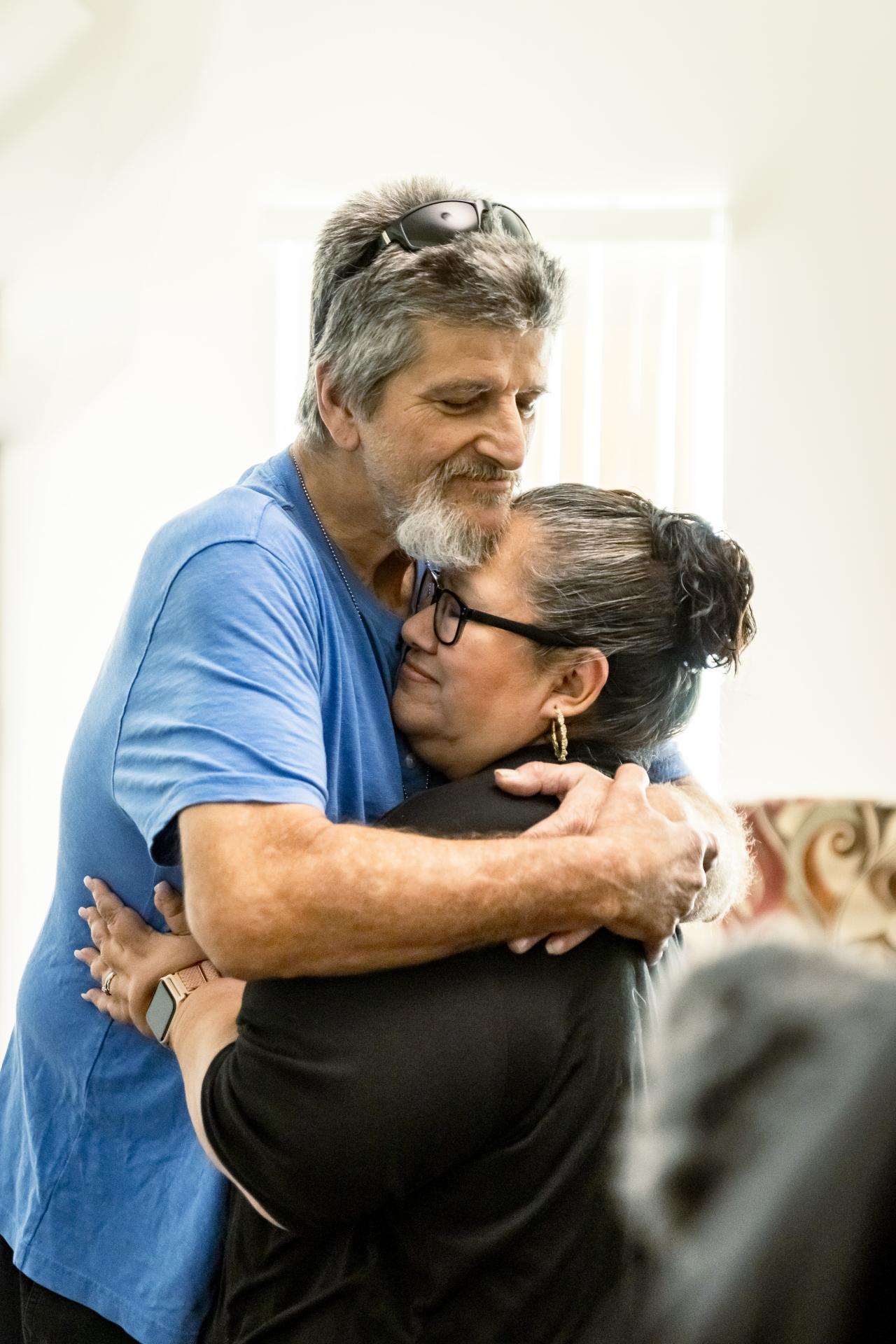 Kenneth Gutierrez hugs his case manage Stephanie as he gets the keys to his new apartment