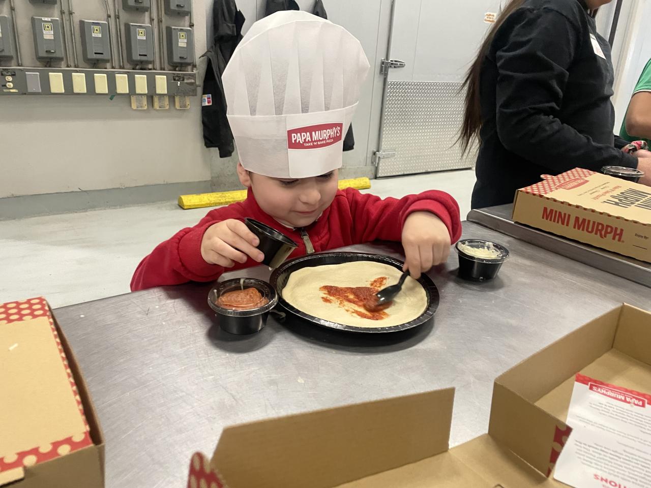 Dream center student making making pizza