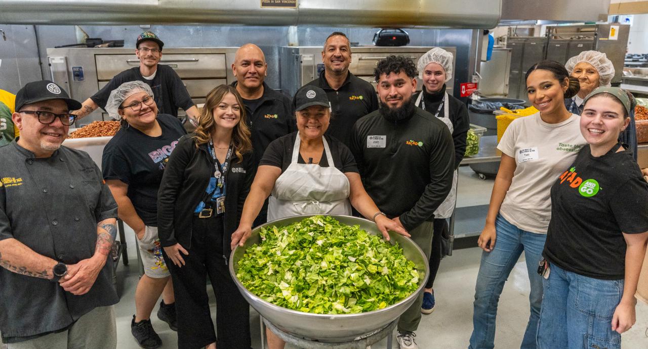 Representatives from Salad and Go stand with SVdP kitchen staff to celebrate the 1,000,000th donated salad.