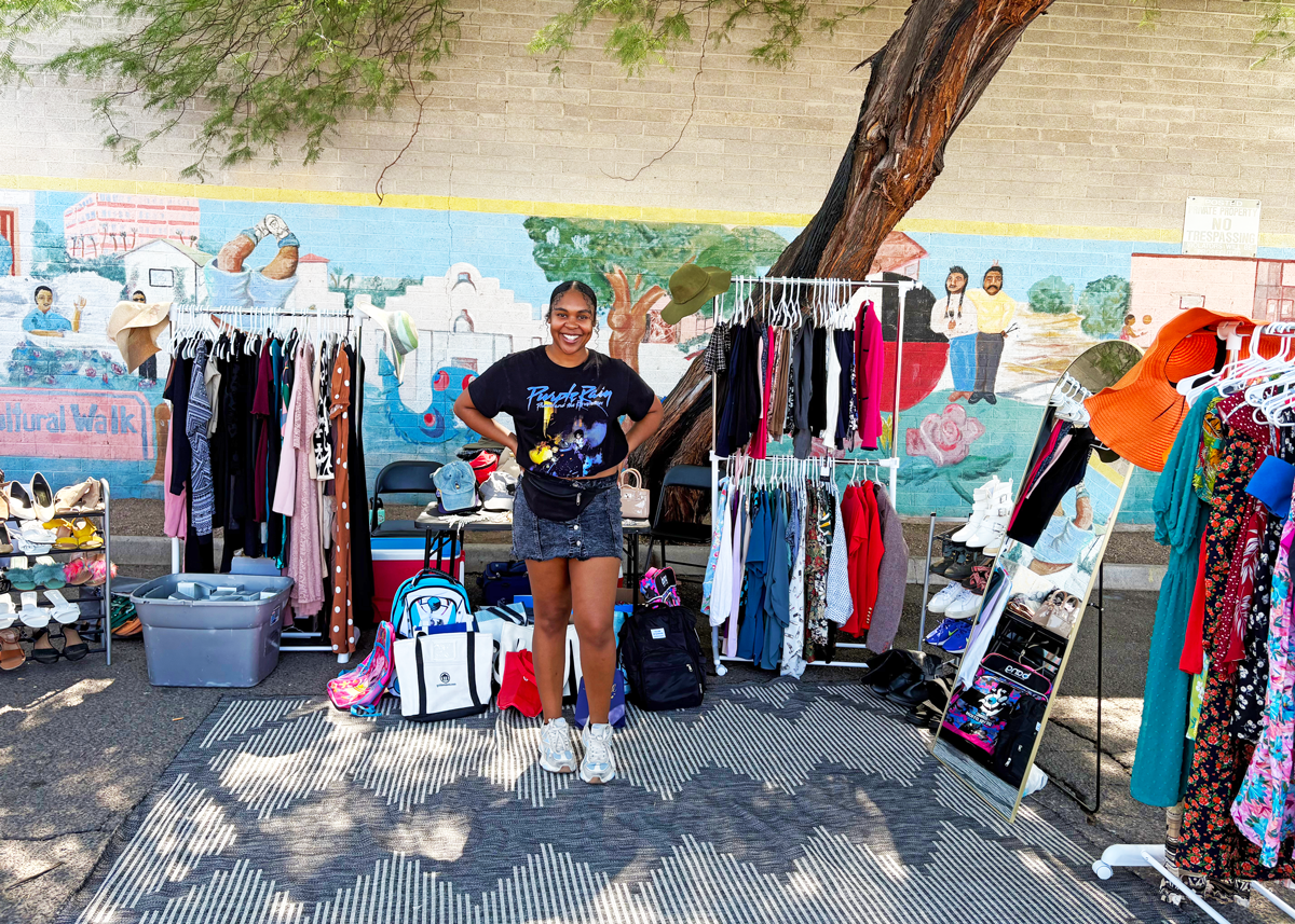 McKayla Banks-Thomas stands at the center of the pop-up clothing boutique she organized for the women guests of Mesa Dining Room.