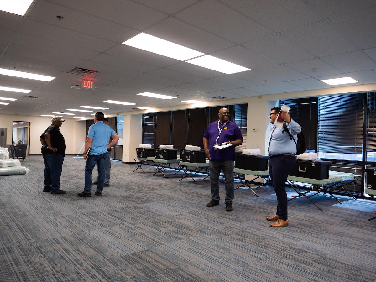 Workers get the shelter space ready.