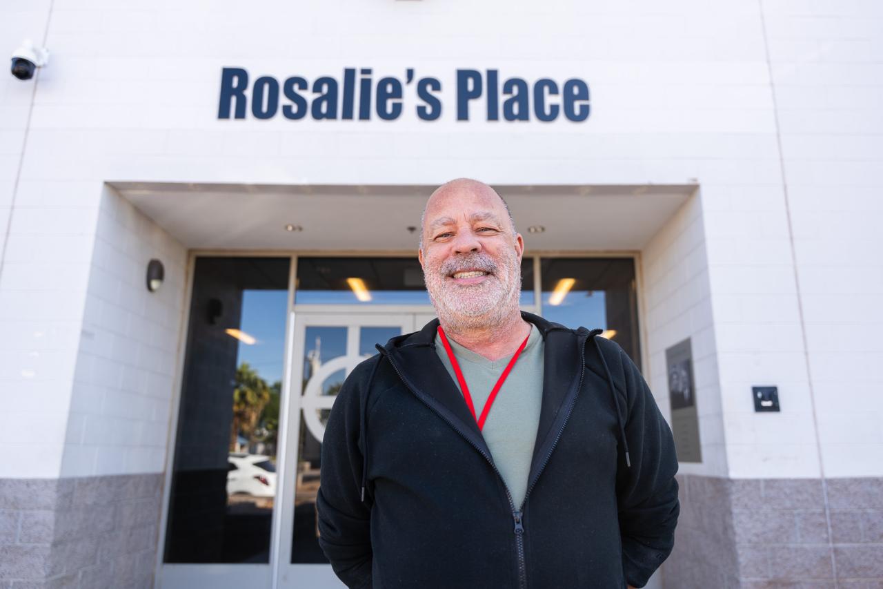 Jon stands in front of Rosalie's Place's front door.