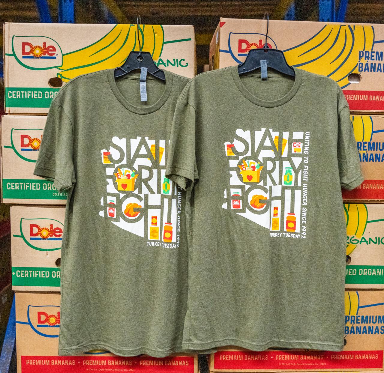 Two State48 shirts hanging up in St. Vincent de Paul warehouse