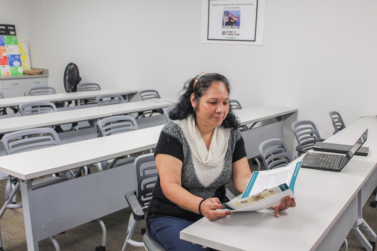 Maria studies a paper from the class at SVdP.