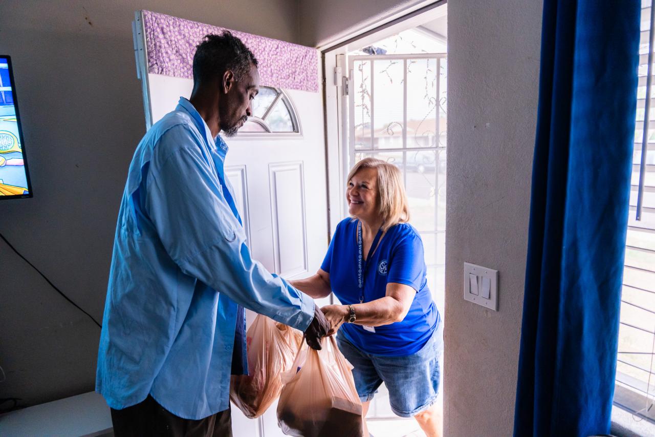 Marc receives food from a Vincentian volunteer.