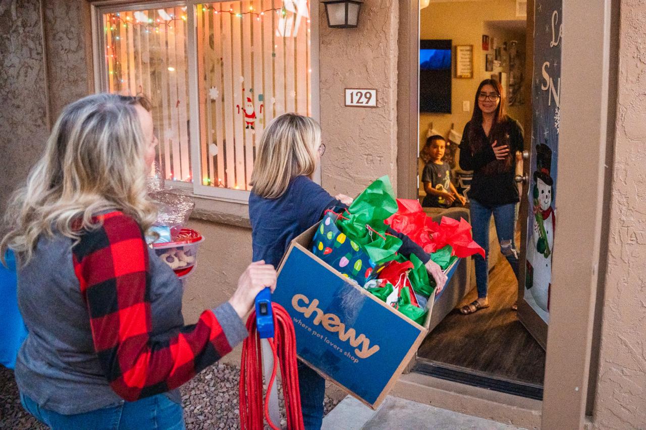 Volunteers bring Betsy and her family presents for Christmas.