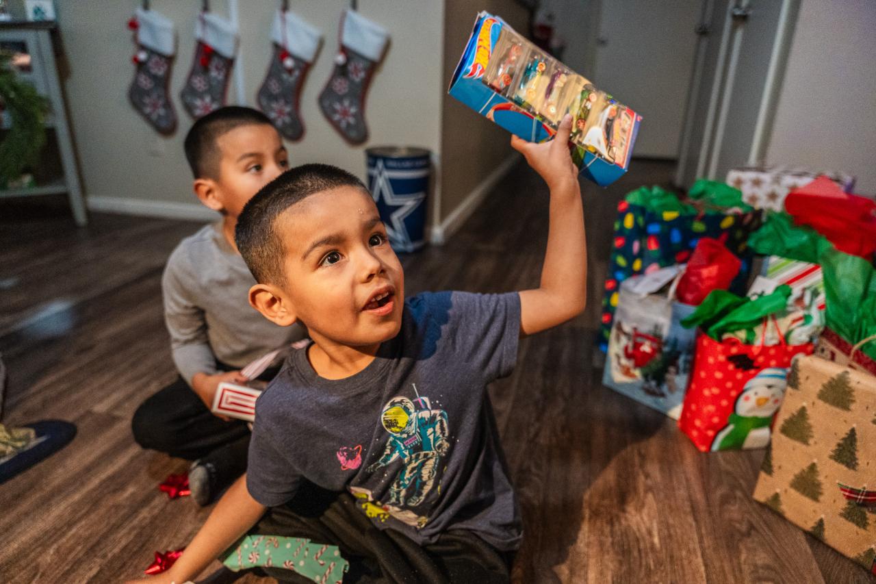 One of the kids holds up his hot wheels received from the AAF program.