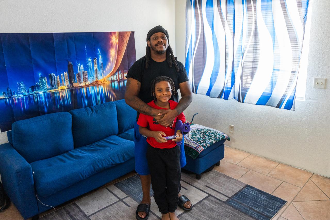 A family that was helped by the HP program stands in the home they were able to stay in. 