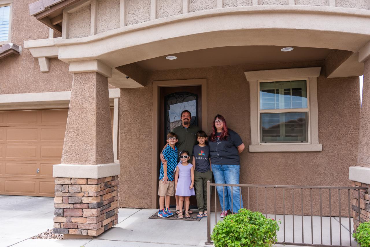 A family who was helped by the HP program stands outside the home they got to stay in. 