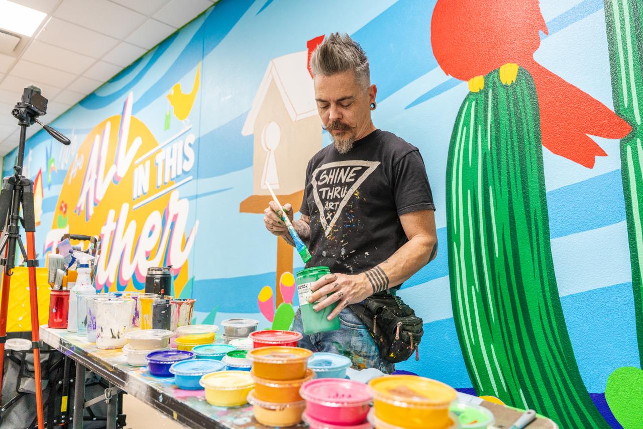 Jesse gets some paint ready for the mural.