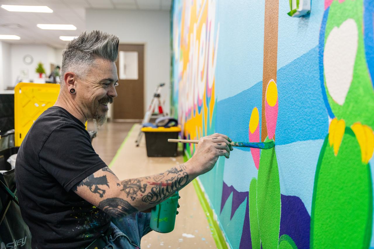Jesse paints the mural.