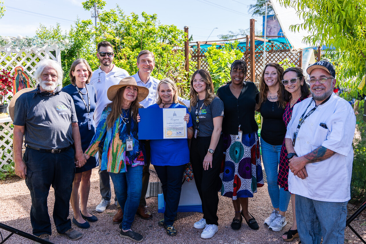 The Mesa Farm volunteers and staff pose with Congressman Stanton and the commendation.
