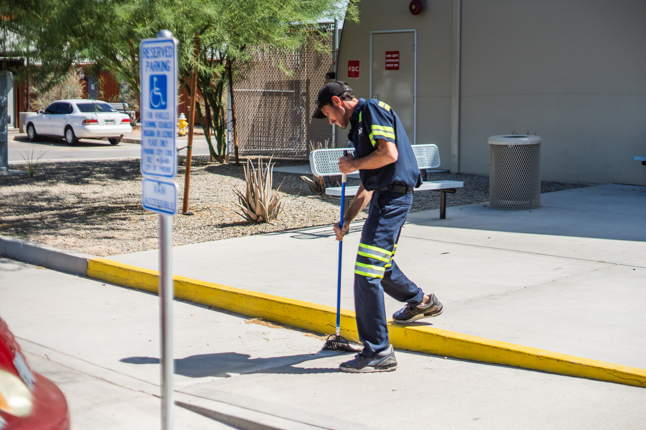 Daniel helps clean up as part of the Neighborhood Brigade.