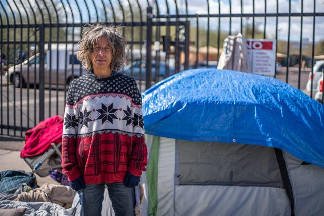 A woman next to her friend's tent in the Zone