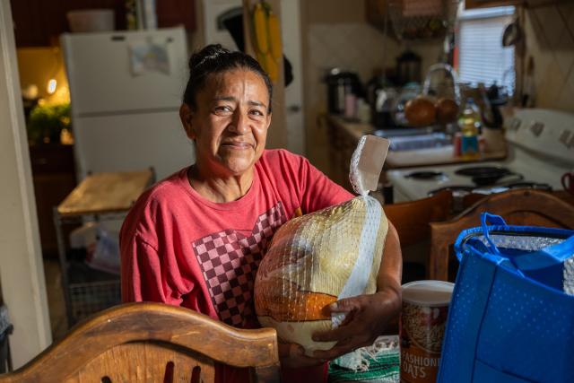 Woman holding a frozen turkey