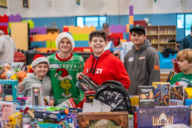 Boys smiling at the camera at Desert Rat toy giveaway